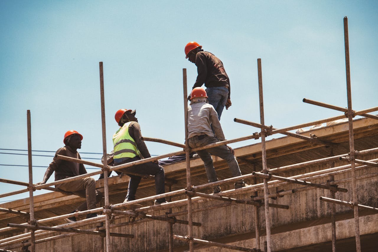 home-hero Construction workers wearing safety gear on scaffolding under clear skies in Nairobi, Kenya.